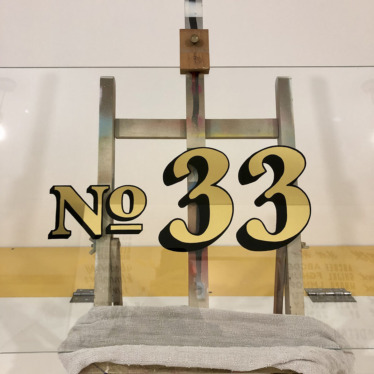 Gold Leaf gilded number 33 on glass for transom window,