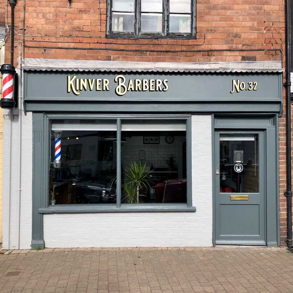 Gold leaf fascia for Kinver Barbers, featuring hand-gilded lettering and classic barbershop styling across a traditional shopfront in the heart of Kinver, Staffordshire