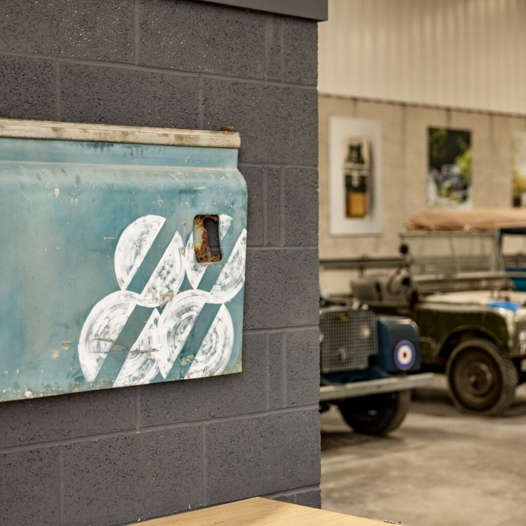 Hand painted graphic detail applied to a vintage Land Rover as part of the Project 88 brand identity, showing bespoke lettering and mark work created by Seven 9 Signs on aged metal.