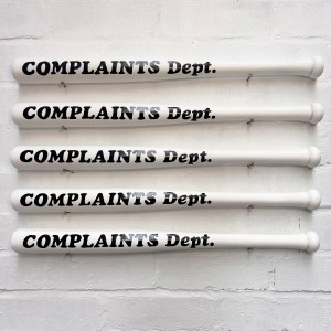 Conversation Piece: White hand painted Complaints Dept bat displayed on wall